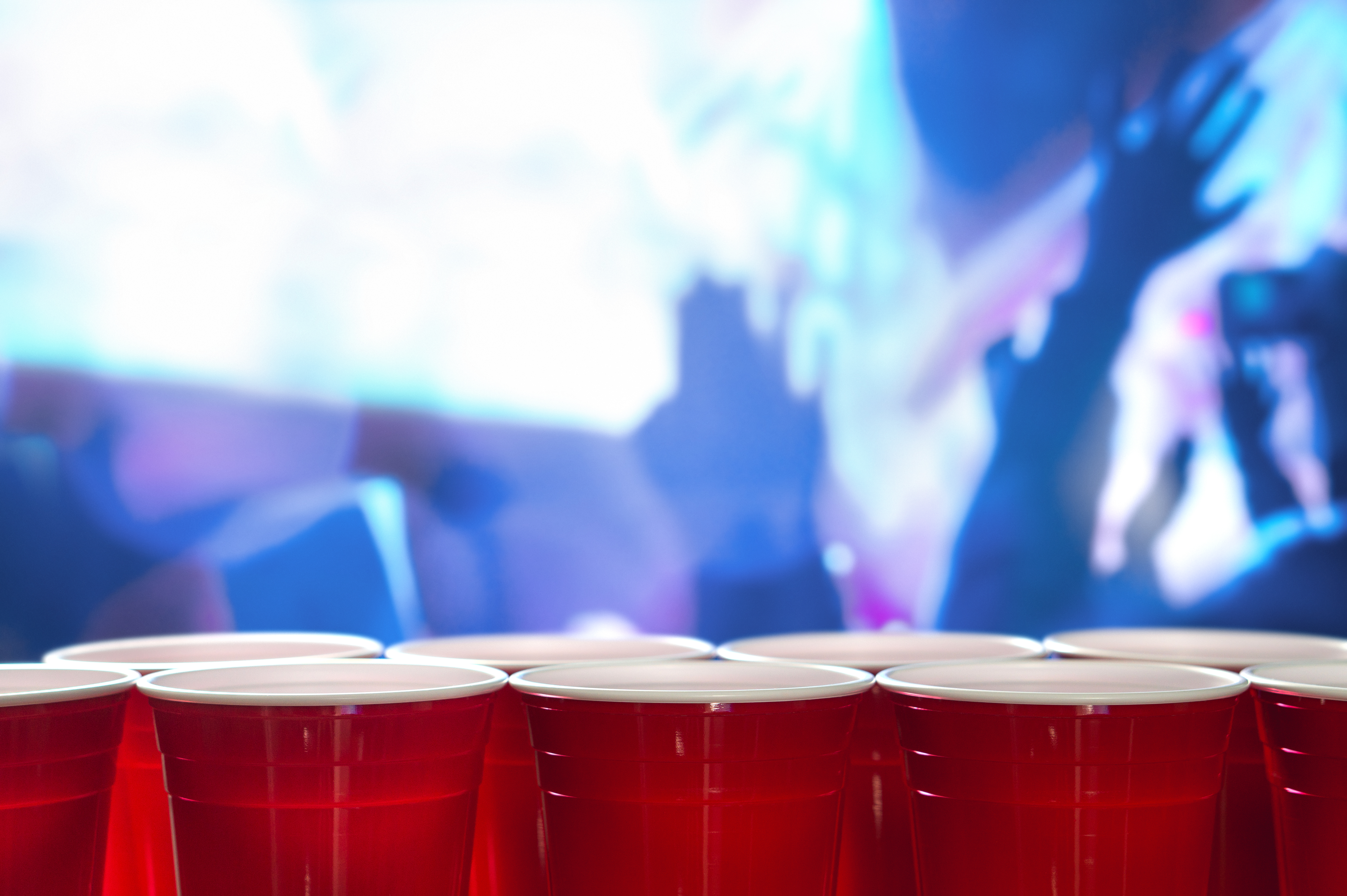 A row of red plastic cups at a college party.