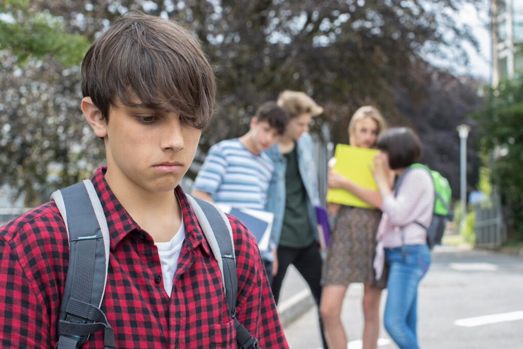 A teenage boy being peer pressured.